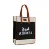 An Airmez tote bag with brown leather handles. The front features a design of a horse-drawn carriage and the text 