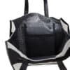 A large open tote bag with black handles and white accents on the sides. The interior is black with a small black mesh pocket attached to one side, providing additional storage space. Branded by Christian Donut, this Christian Donut is empty and standing upright.