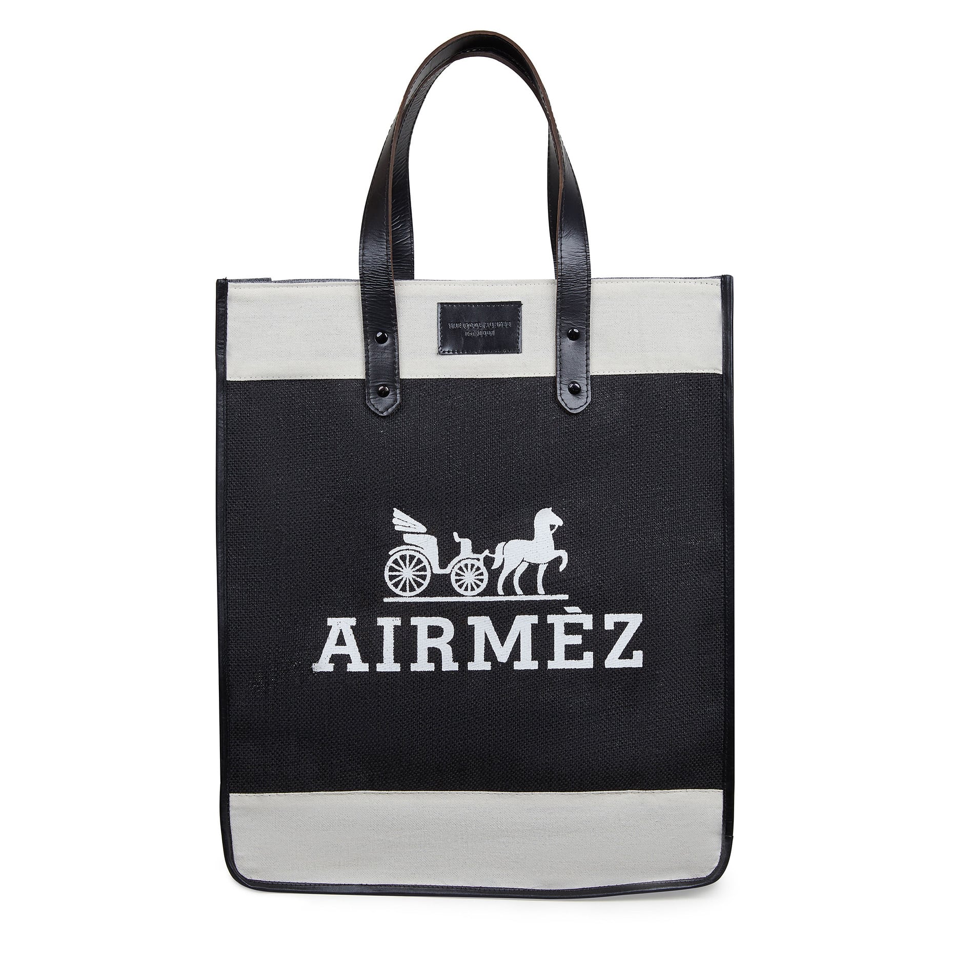A black and white Airmez tote bag with black handles. The bag features a white graphic of a horse-drawn carriage with a rider and the word "Airmez" printed below the graphic.