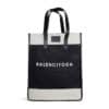 A black and white tote bag with leather handles features the text 