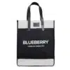 A black and white tote bag with black handles. The Blueberry features the text 