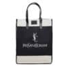 A black and white tote bag with black leather handles. The front displays 